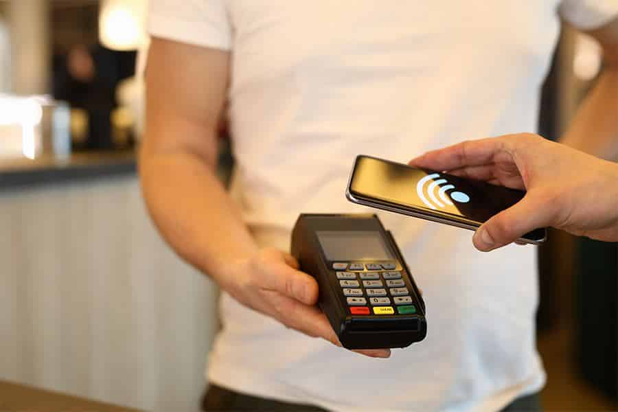 erson making payment via terminal and mobile phone