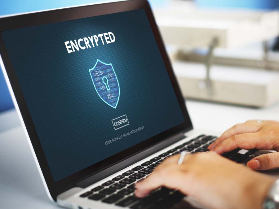 Laptop with Encrypted online security protection concept on its screen