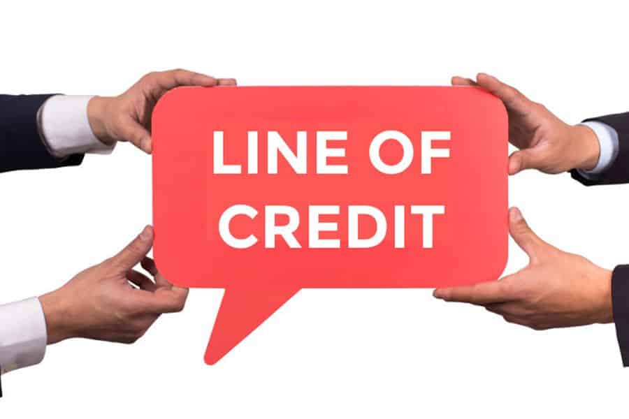 hands hold card with text: line of credit