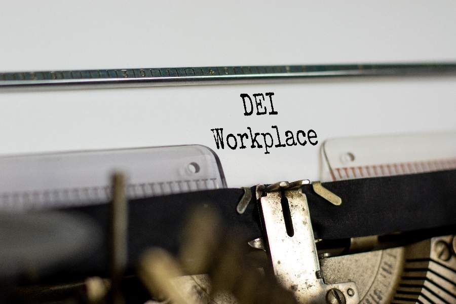 The words "DEI Workplace" typewritten on a paper.
