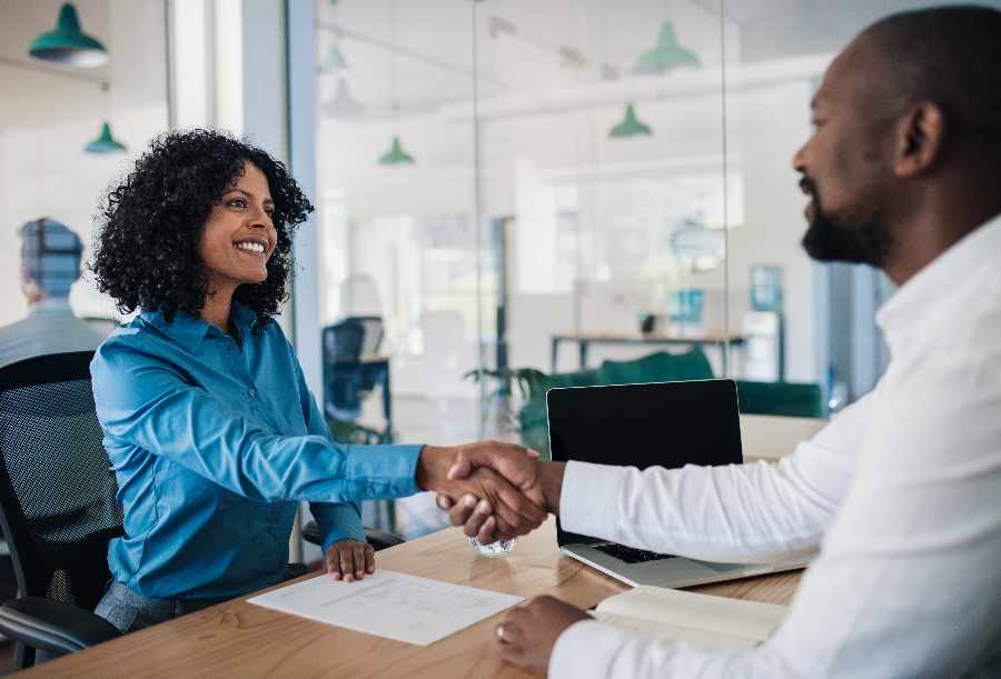 Interviewer hand shaking an applicant.