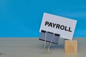 Payroll written on a paper with a paper clip.