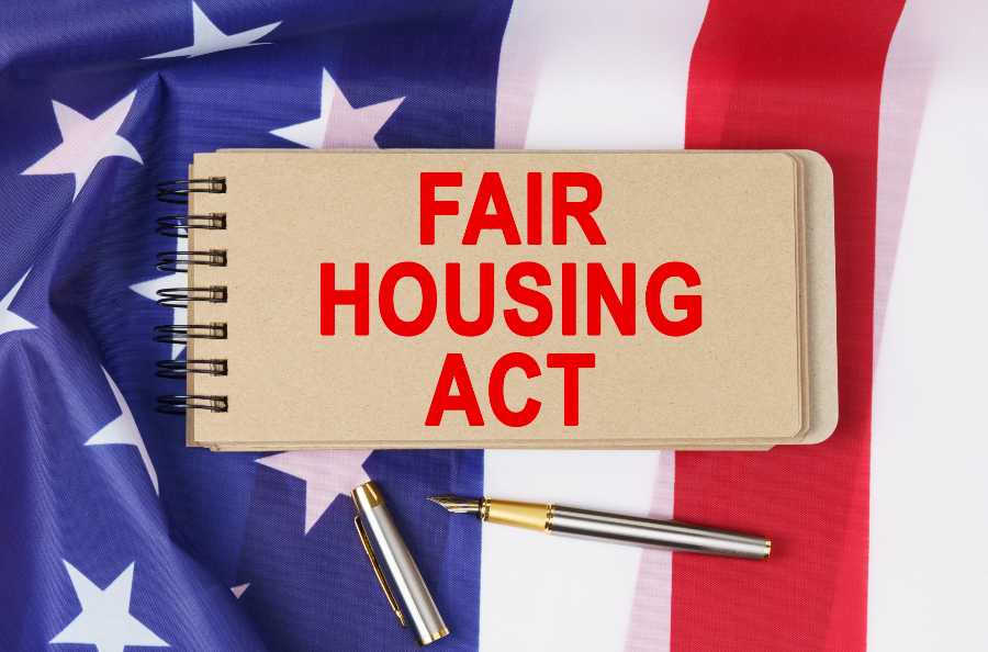 A note on top of the USA flag with writings "FAIR HOUSING ACT."