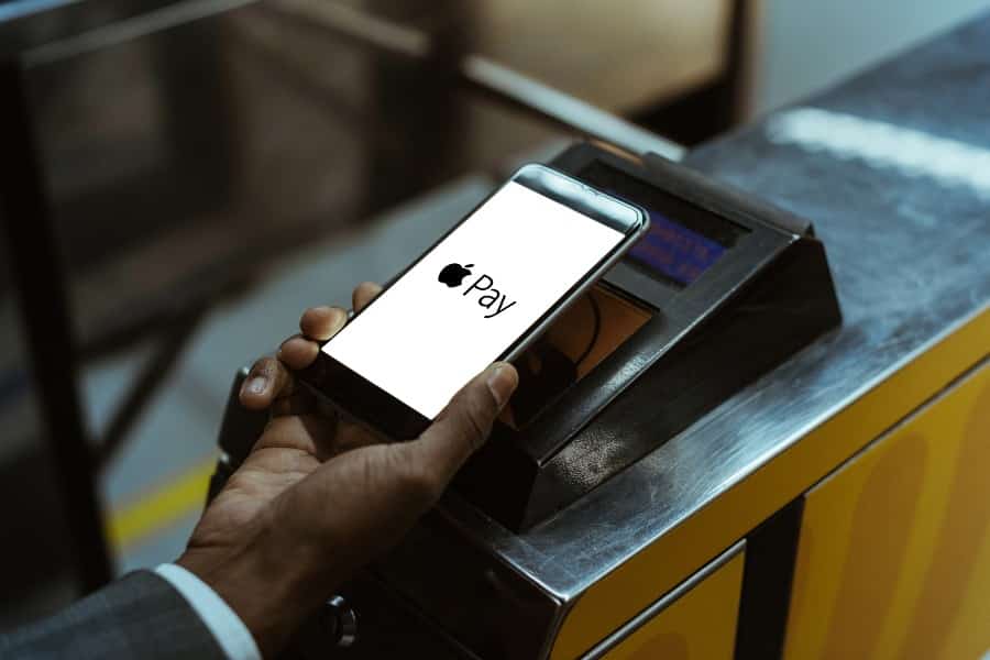 Close up shot of a man using Apple Pay paying for public transport.