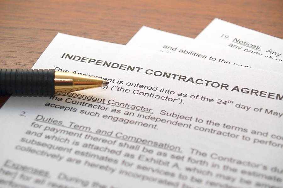 Independent contractor agreement form with pen.