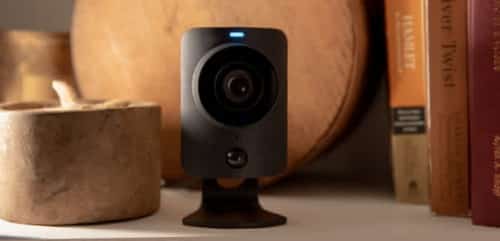 Showing SimpliSafe's black wireless camera on the table.