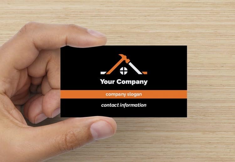 Simple design of a construction business card with orange icons.
