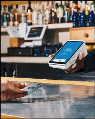 Transaction using credit card on a Square card reader.