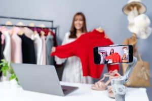 Woman taking a photo of a clothing to sell online.