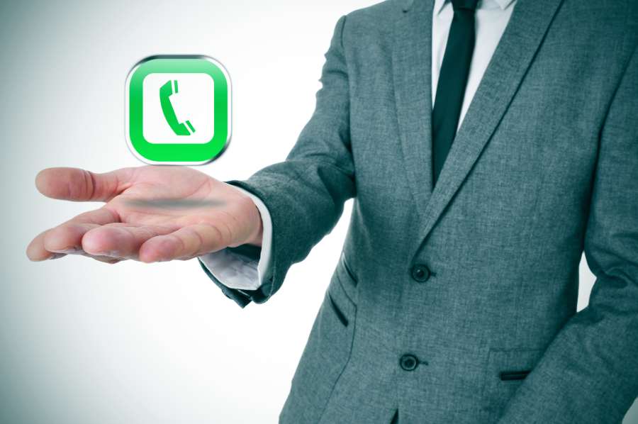 VoIP telephone icon on a businessman's hand.