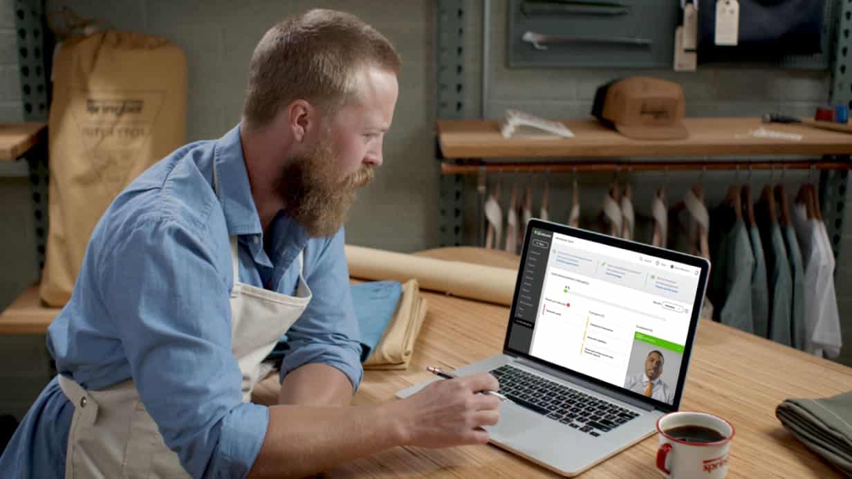 A guy in laptop while using QuickBooks Live Bookkeeper app.