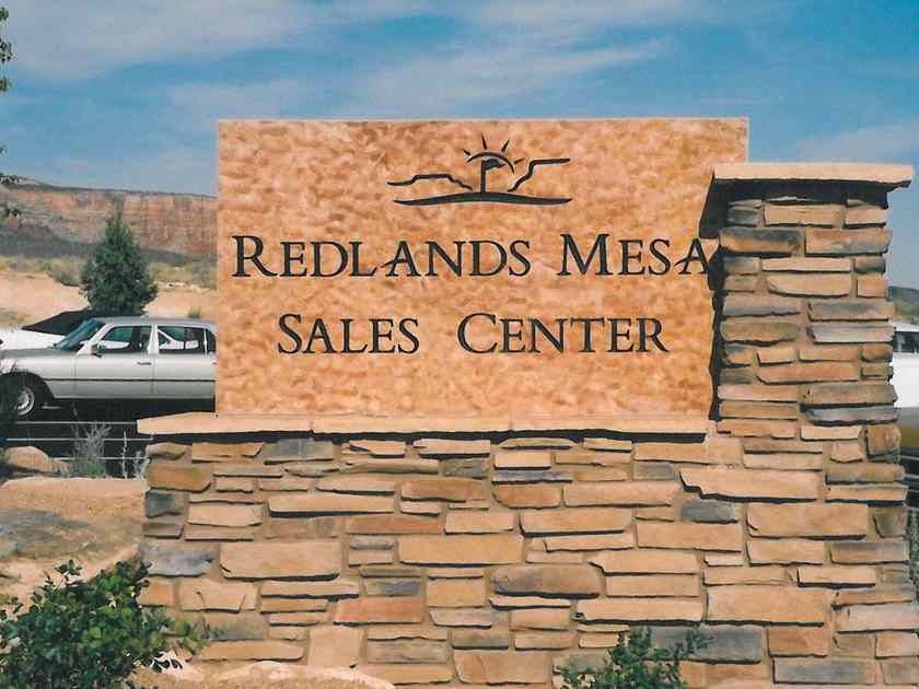 Showing Redlands Mesa Sales Center rock signage.
