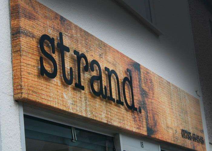 Showing Strand plywood storefront sign.