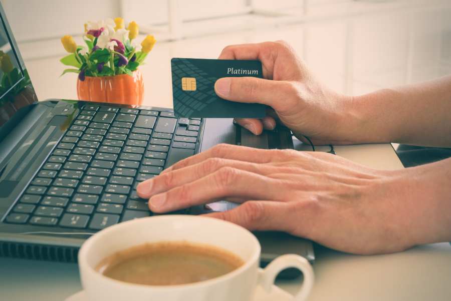 A male using his credit card online.