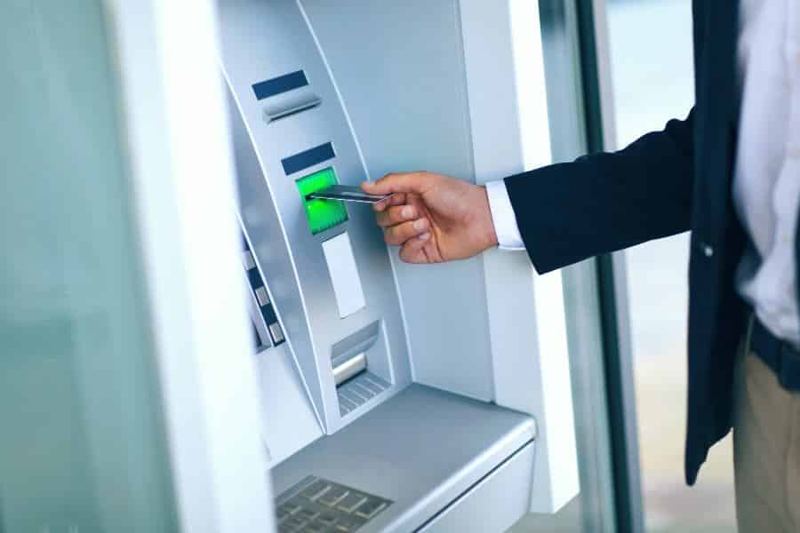 Man Using Credit Card To Withdraw Money From Atm Machine.