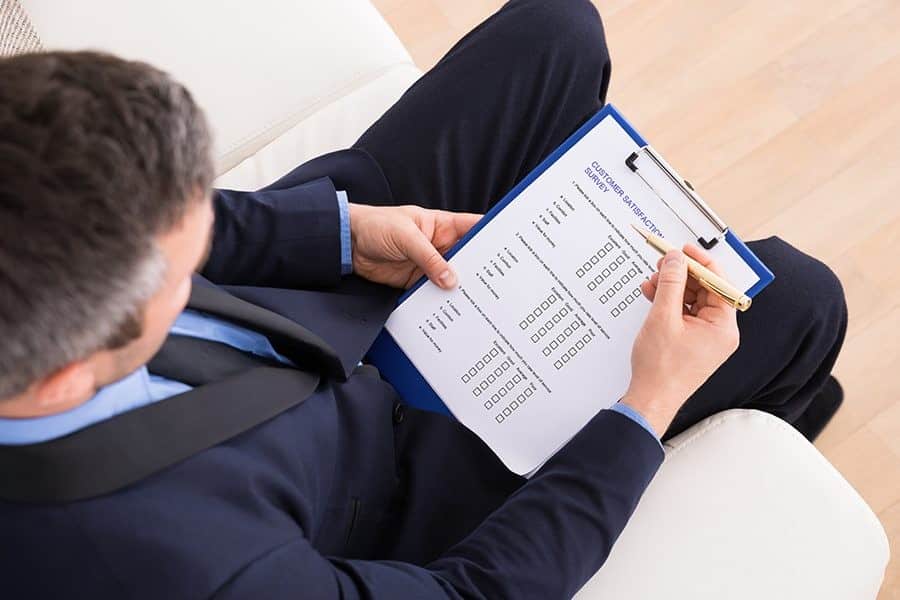 Man in business suit filling up a questionaire.