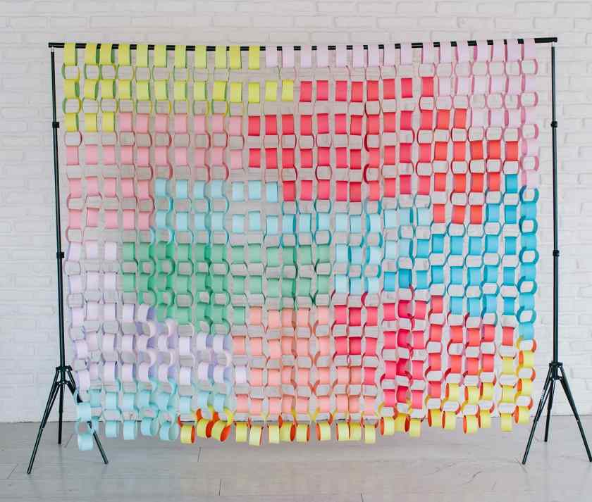 Showing colorful paper chains arranged on a backdrop stand.