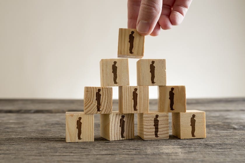 A hand stacking the wooden blocks.