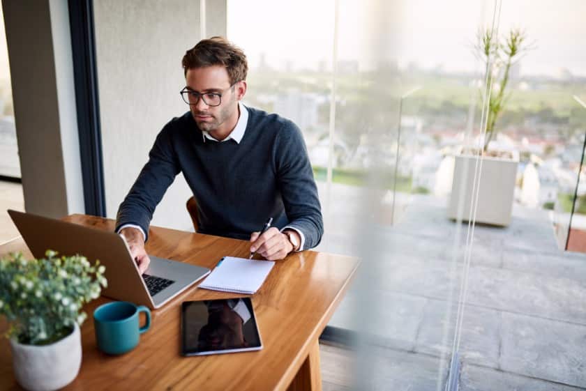 Showing a man wearing layering sweater over a collared shirt for the meeting.