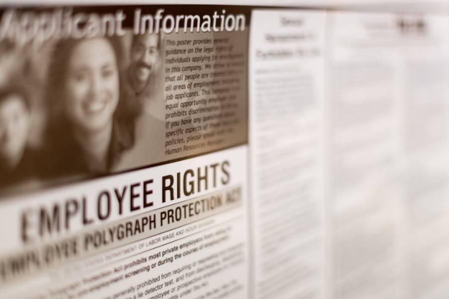 Showing an employee rights poster.
