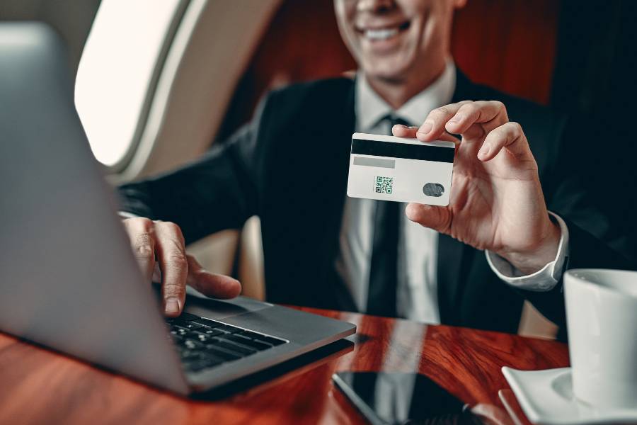 Businessman holding a credit card while on travel.