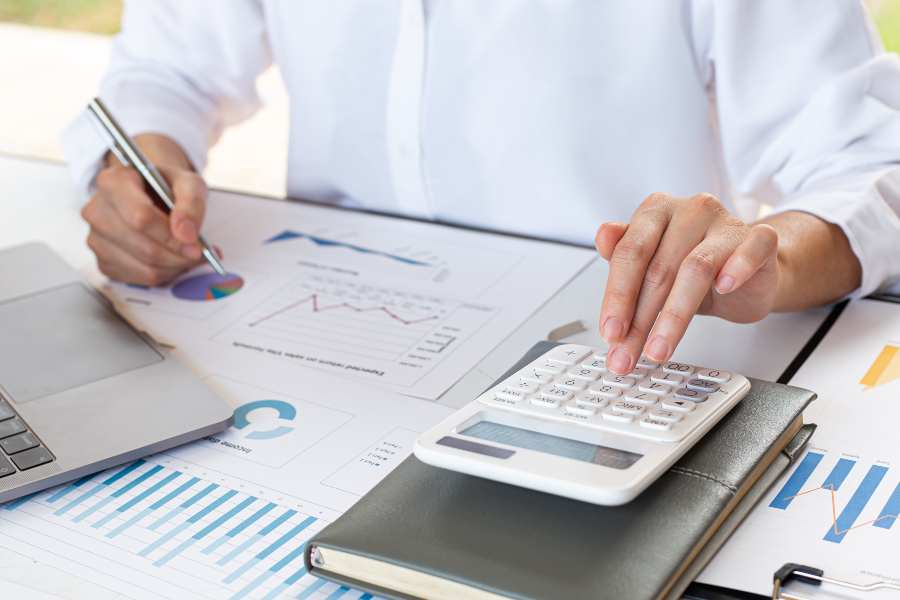Accounting businessmen is calculating income expenses and analyze real estate investment data.