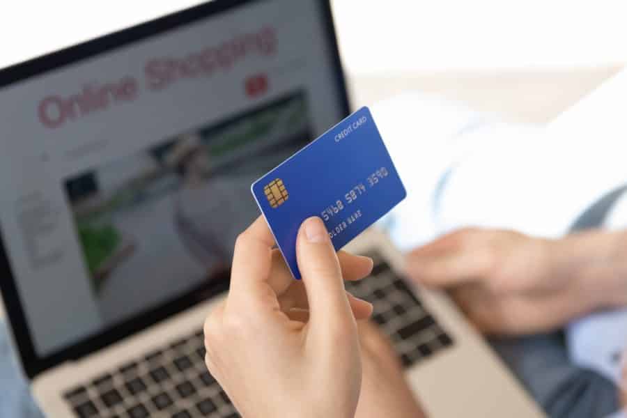 Showing a buyer, using a credit card to shop online.
