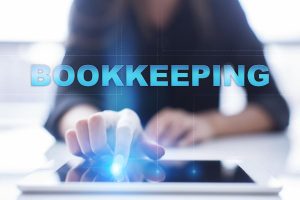 Woman is using tablet pc, pressing on virtual screen and select "Bookkeeping".