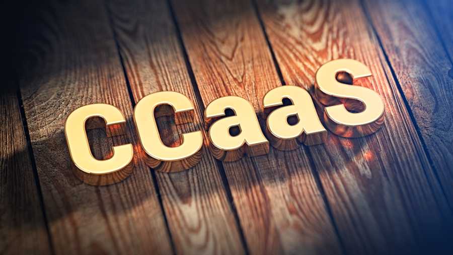 CCaaS acronym in gold letters on wooden background.