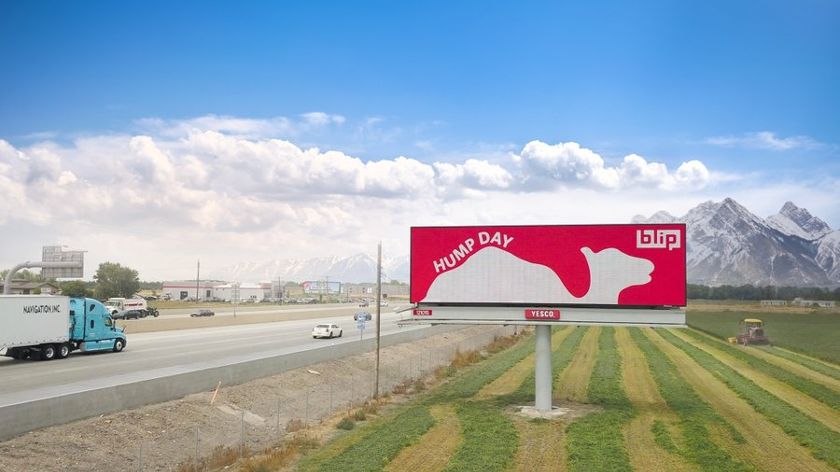 Blip digital billboard standing on the field beside the highway.