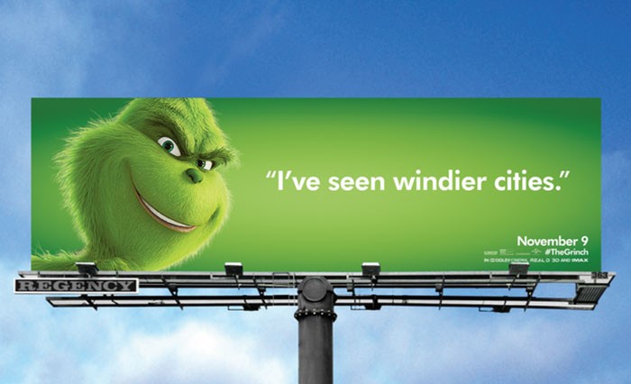 A billboard advertising the movie "The Grinch" in Chicago saying "I've seen windier cities."