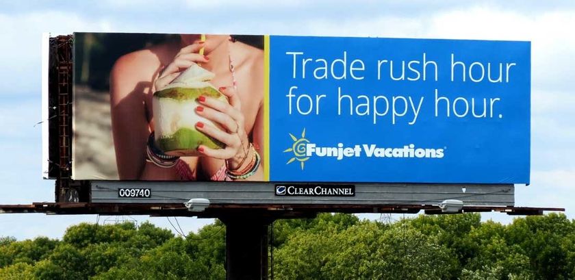 ClearChannel billboard with blue background and a woman drinking coconut juice.