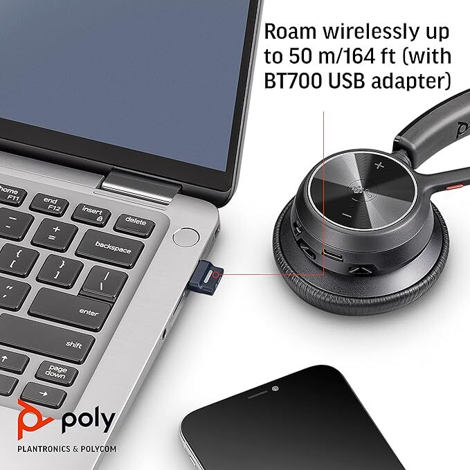 Flat lay image showing a single ear piece along parts of laptop and iPhone.