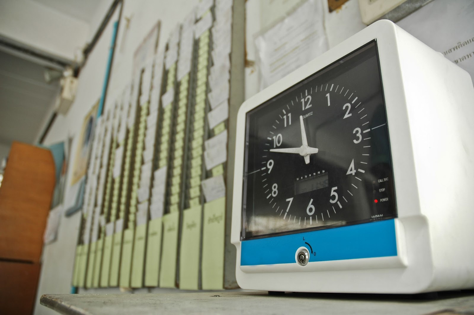 A Wall-mounted punch time clock.