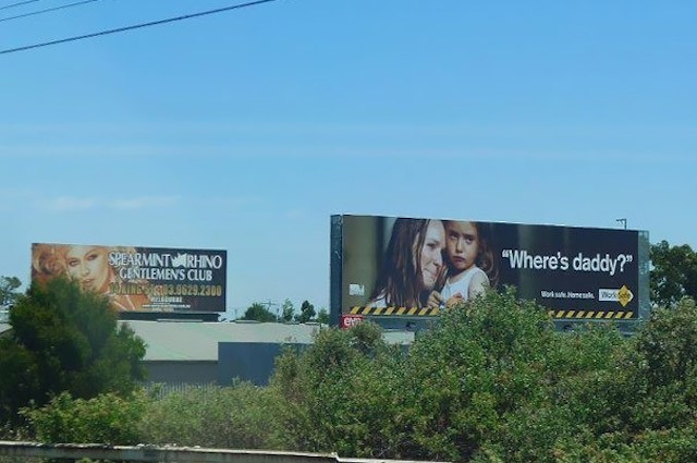 An example of badly placed billboard partly covered with trees.