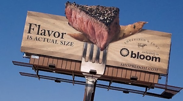 An example of non-traditional billboard extends above the billboard visually and emits a scent
