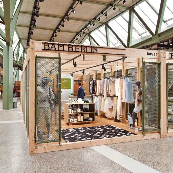 Free standing wooden popup store in open space.