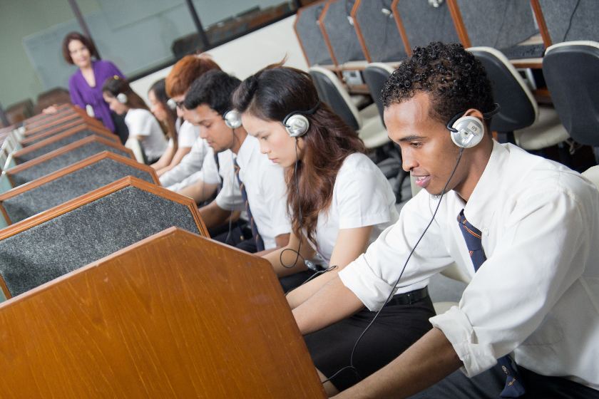 Students taking real estate exams on the computer.