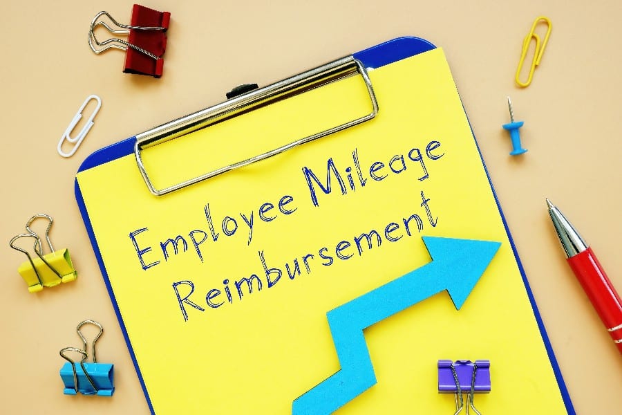 Employee Mileage Reimbursement written on a yellow paper.
