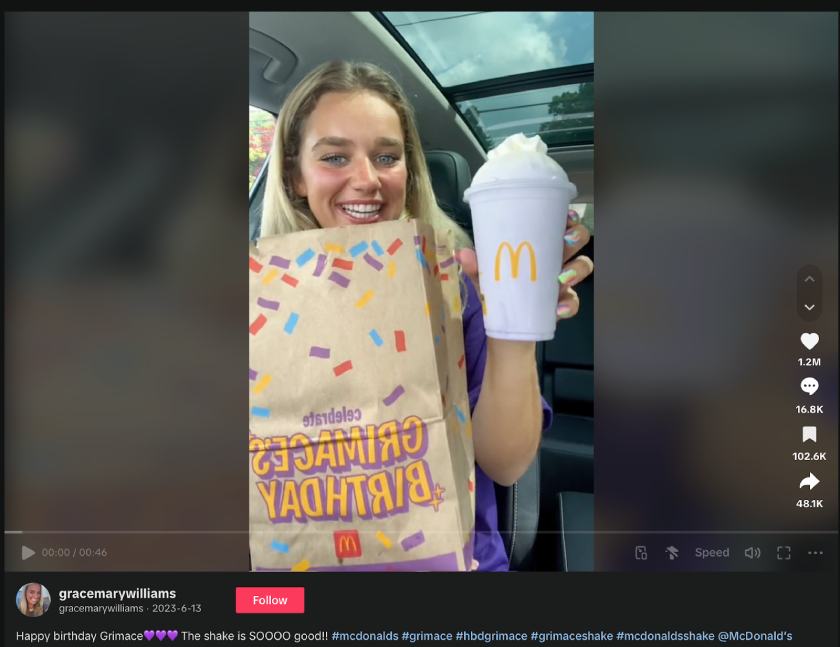 A screenshot of a TikTok user holding up a Grimace Shake from McDonald's.