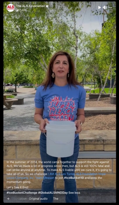 A woman holding an ice bucket as part of the Ice Bucket Challenge.