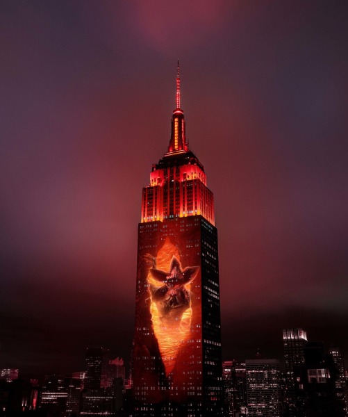 The Empire State Building with a projection of a monster from the TV show "Stranger Things."