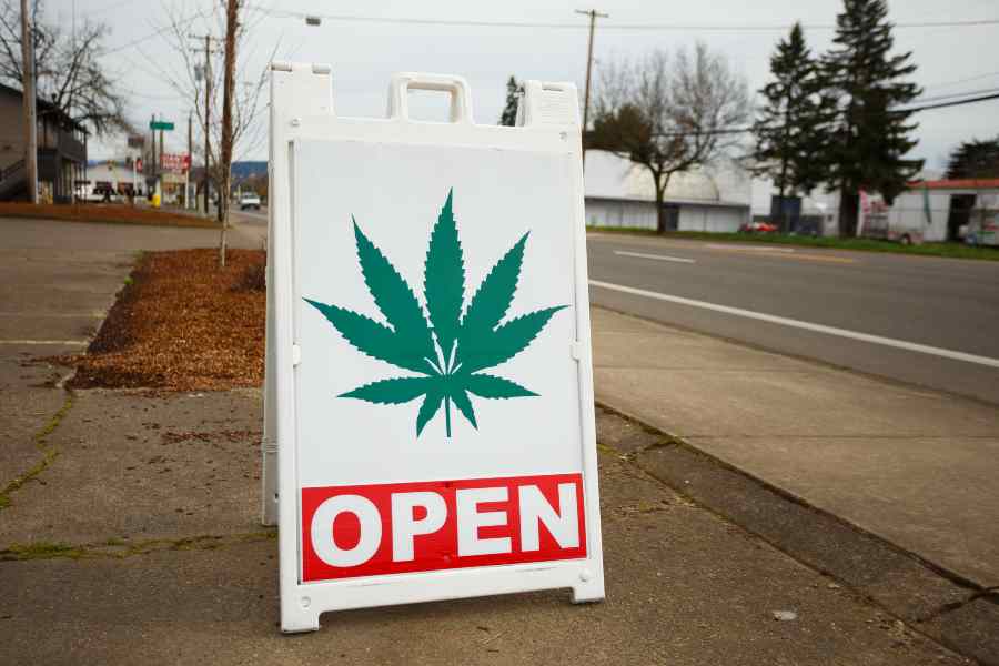 Signage with saying OPEN and a Cannabis.