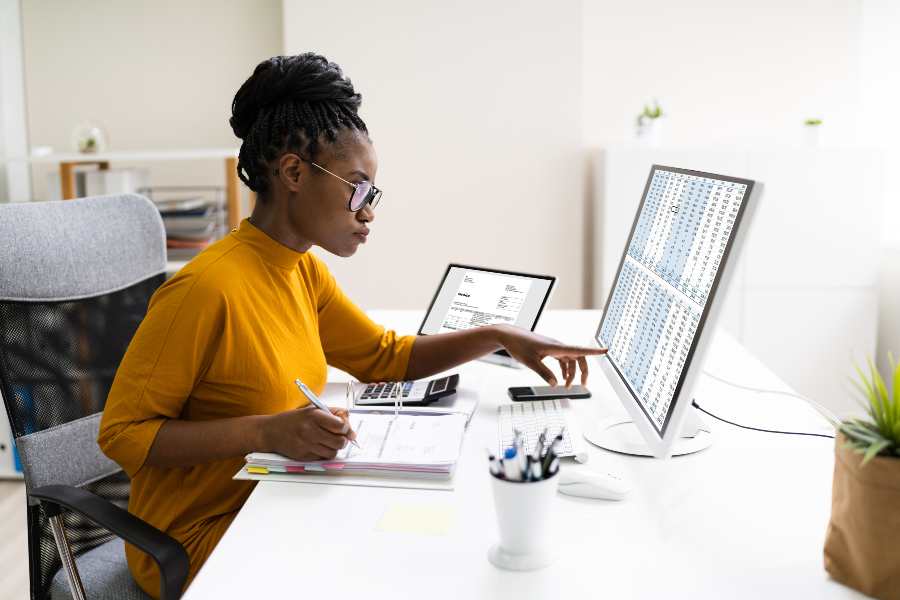 Young woman is working in front of her computer.