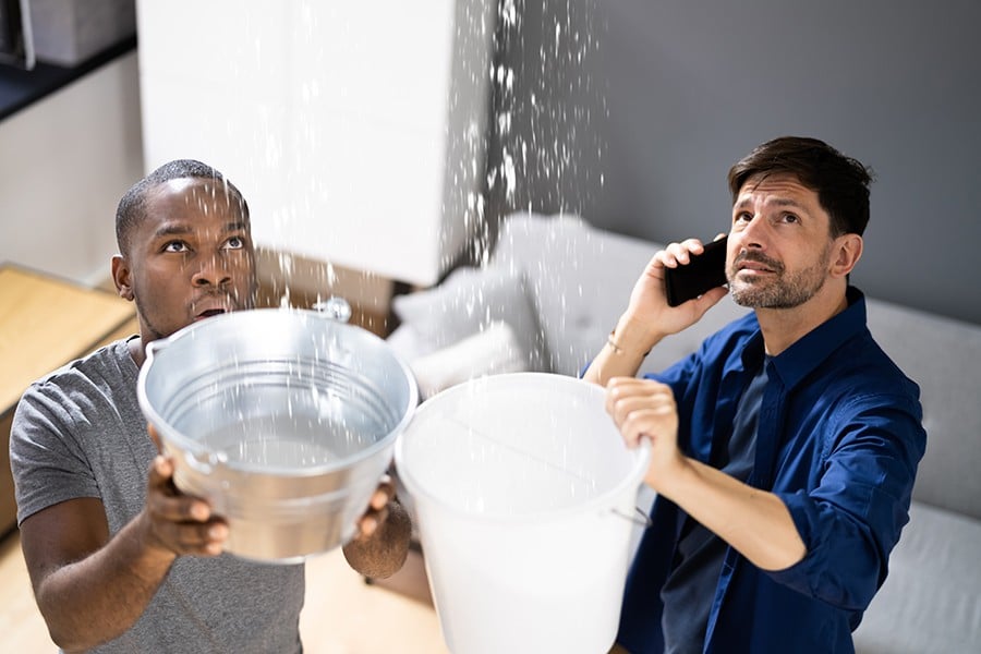 Two men having an emergency leaking roof problem.