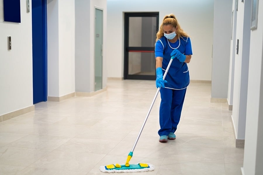 Cleaning lady mopping the floor.