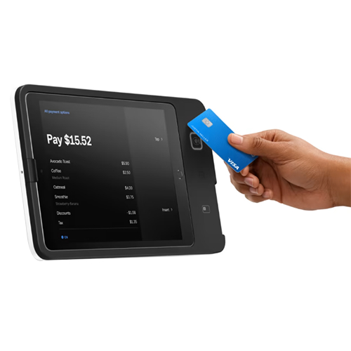 Customer tapping credit card on a wall-mounted Square for Restaurants POS screen.