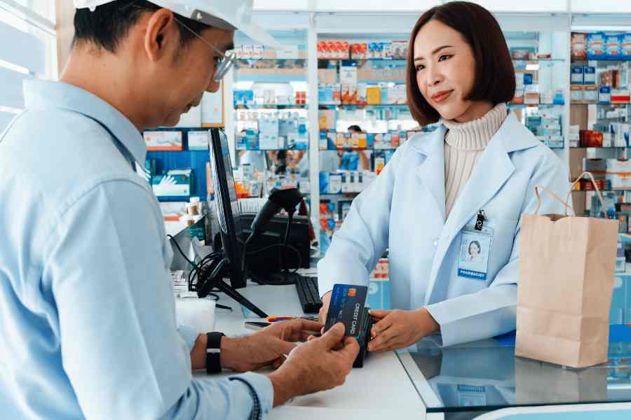 Pharmacist entertaining a customer's order.