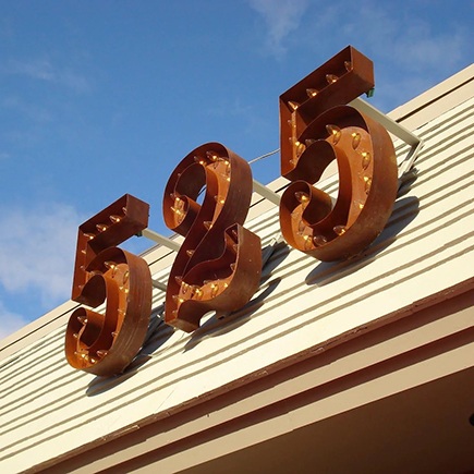 A marquee sign mounted on a store's roof