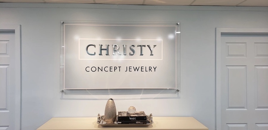 Acrylic sign mounted on the wall of a jewelry store